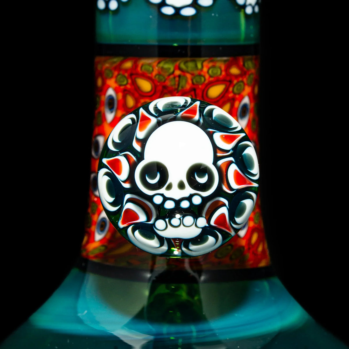 Close-up of intricate glass art featuring a white skull design with colorful accents.