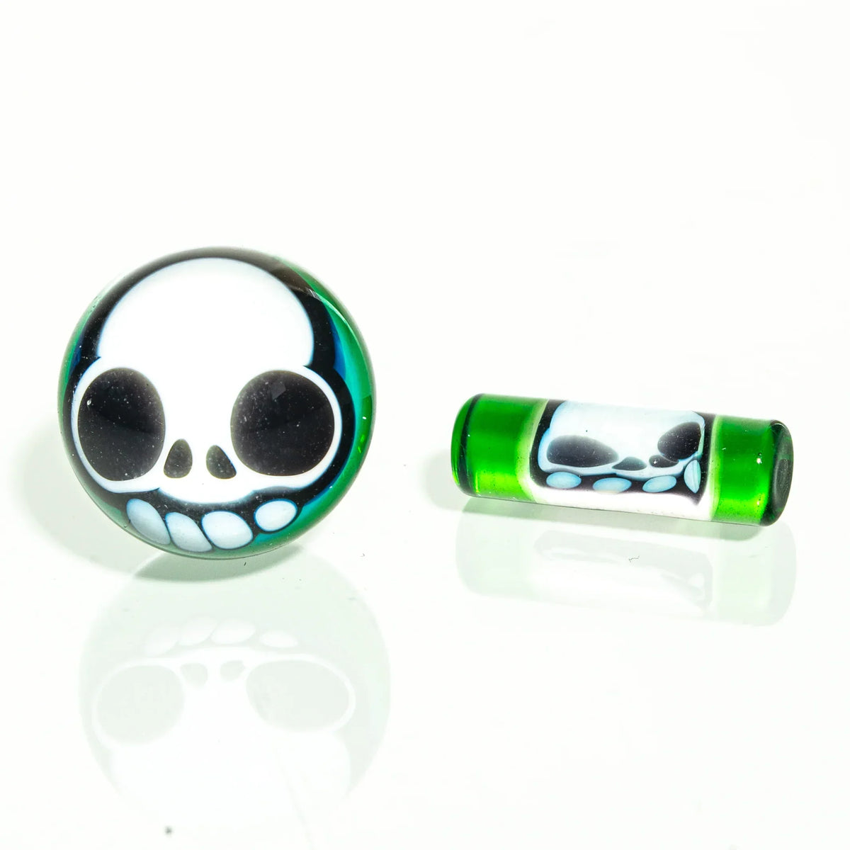 Green glass terp pearls and pill with skull design on white background