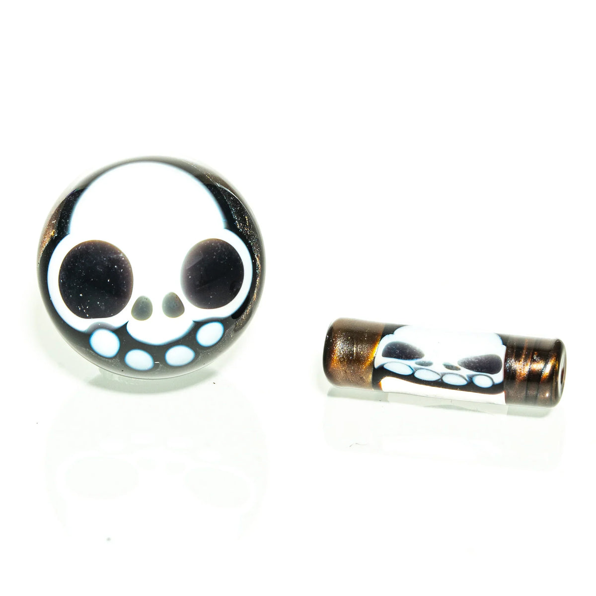 Glass carb cap and accessory with white skull design on a clean white background