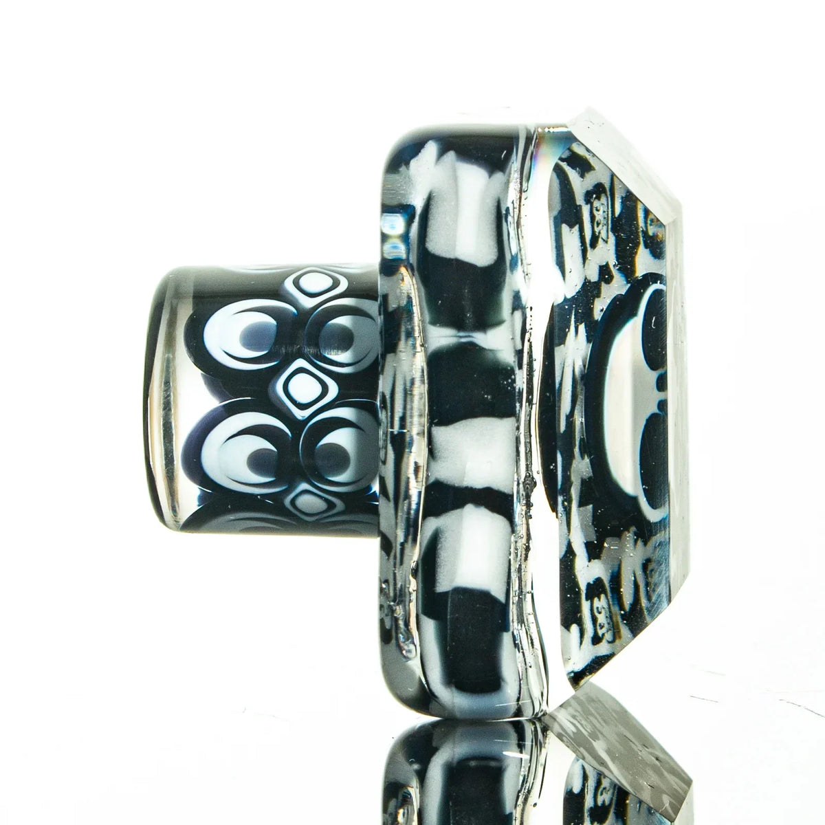 Handcrafted glass carb cap with black and white geometric patterns for dab rigs