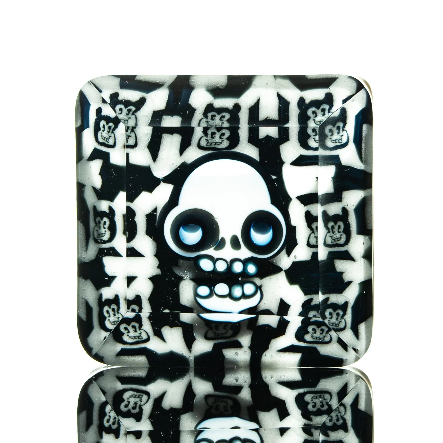Square glass tray with cartoon skull and bear faces in black and white pattern