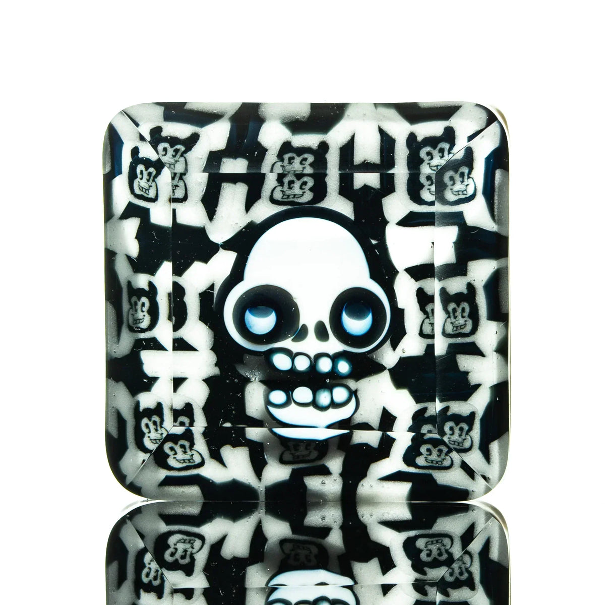 Square glass tray with cartoon skull and bear faces in black and white pattern