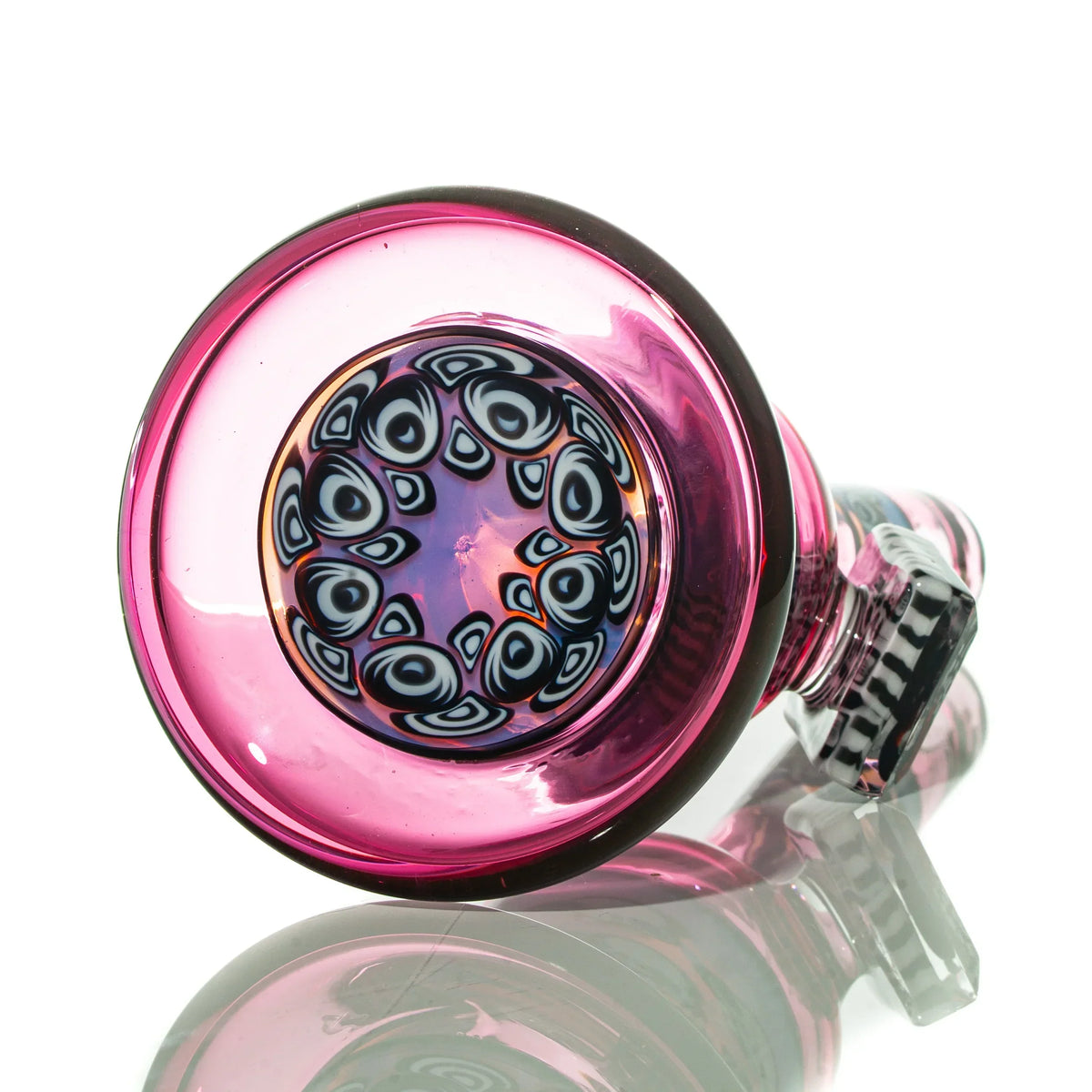 Pink glass water pipe with intricate patterned base and clear accents on white background