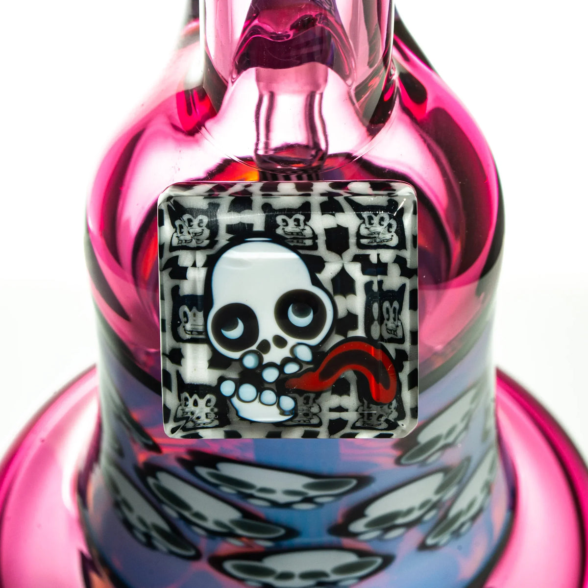 Close-up of pink glass water pipe with skull and cartoon pattern accents