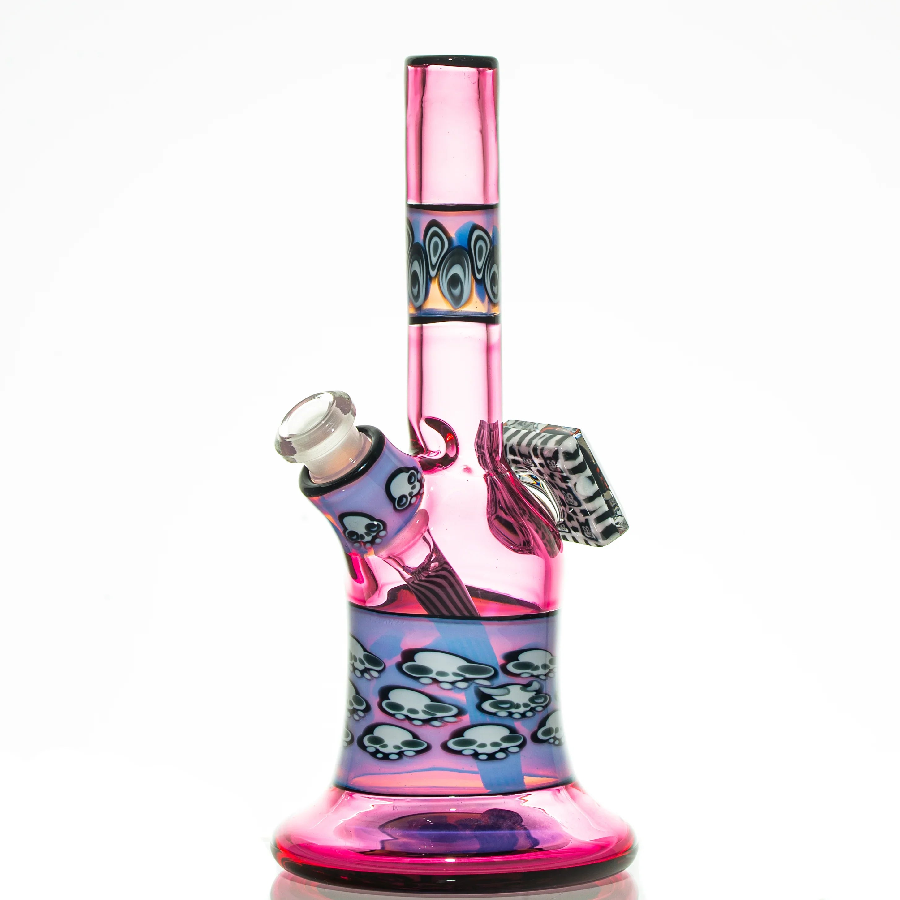 Pink and blue glass water pipe with skull designs and intricate patterns, on white background
