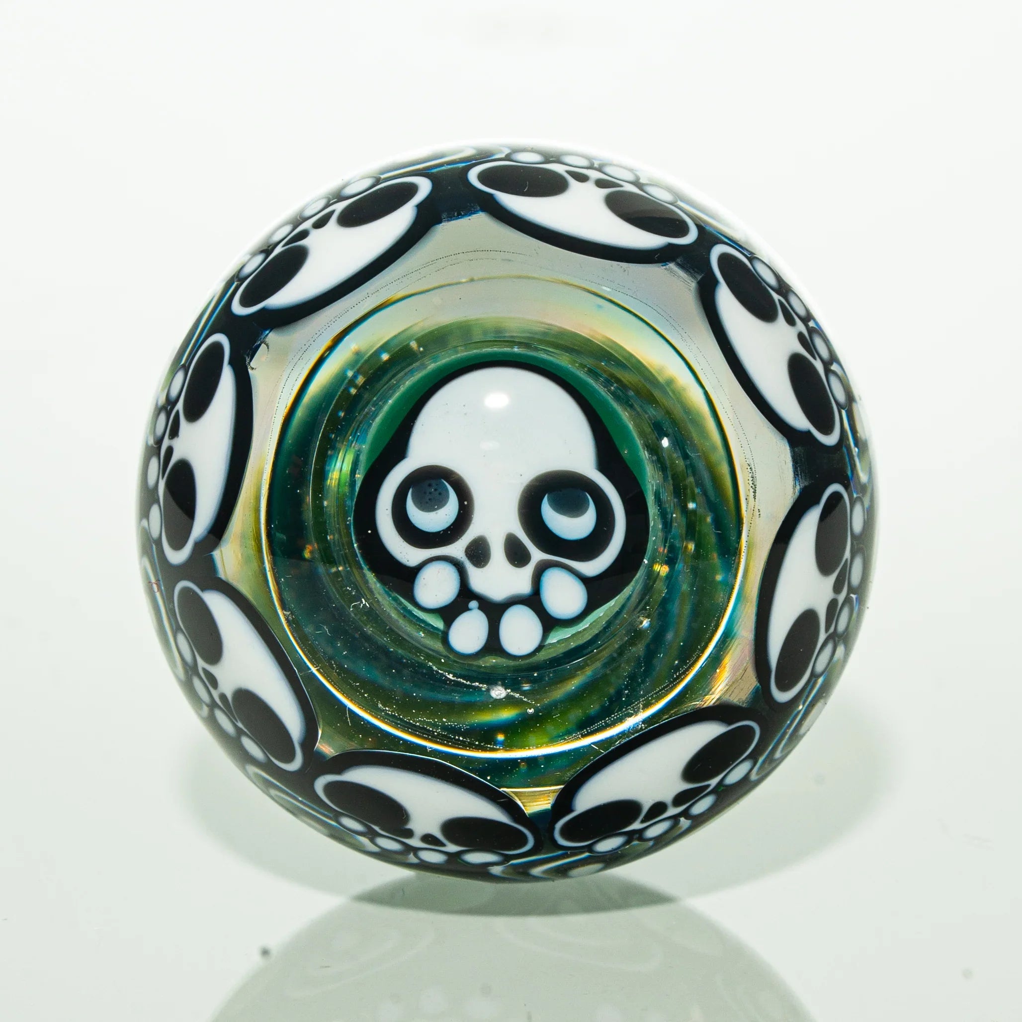 Glass marble with skull design and black and white accents, smoking accessory