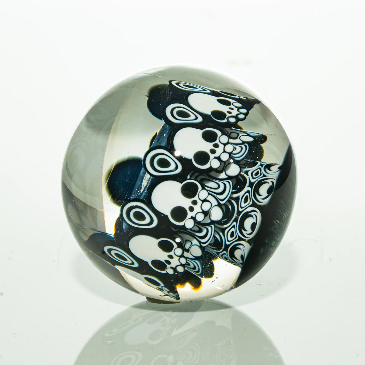Handcrafted glass marble with black and white skull designs, art glass accessory