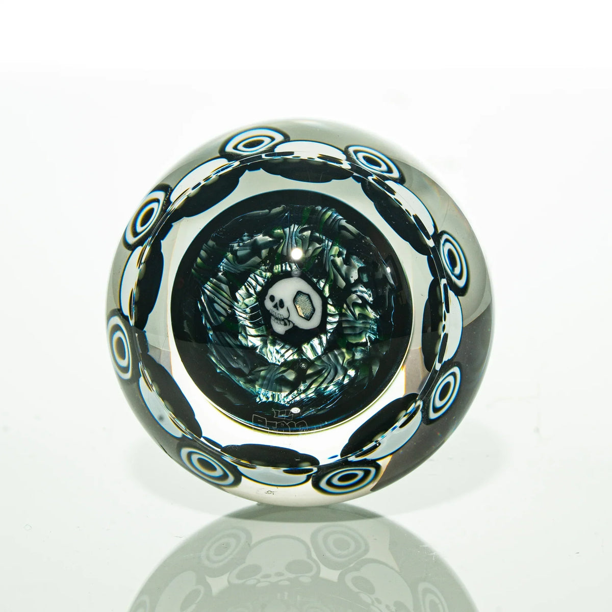 Handcrafted glass marble with skull design and intricate colored patterns