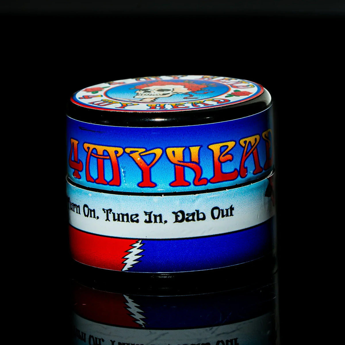 Colorful dab container with retro graphic, Grateful Dead-inspired design, and slogan text