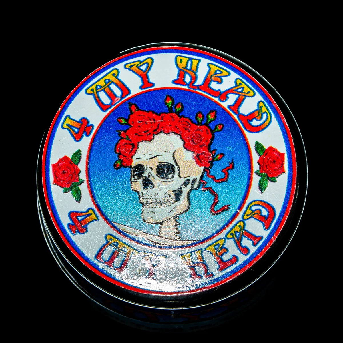 Herb grinder with colorful skull and roses artwork, 4 Up Head text, vibrant design