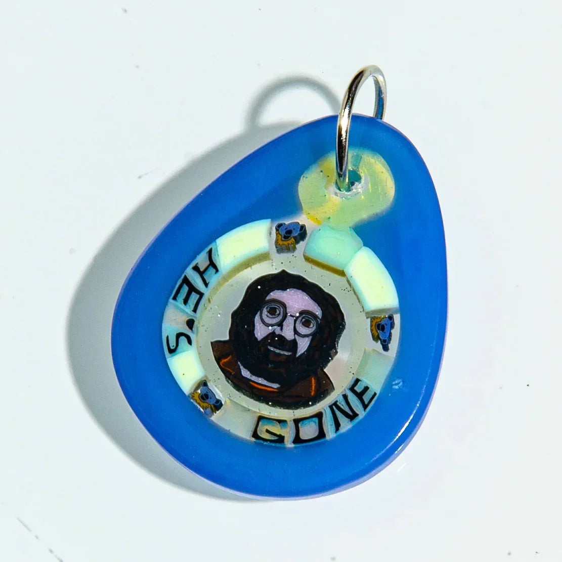 Blue glass keychain with cartoon bearded face and 'HE'S GONE' text, handmade accessory