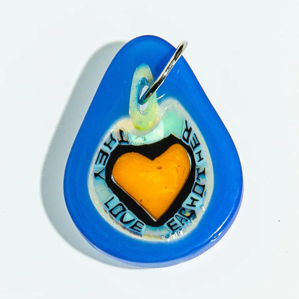 Blue glass keychain with yellow heart and 'They Love Each Other' text, on white background