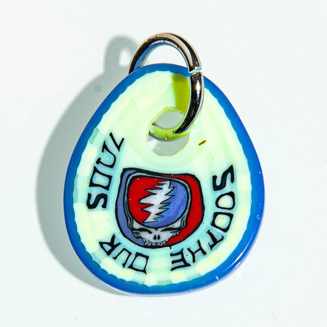 Glass keychain with blue edge, lightning skull graphic, and text 'SOOTHE OUR SOULS'.
