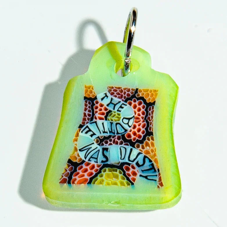 Colorful glass keychain with patterned background and text, metal key ring attached