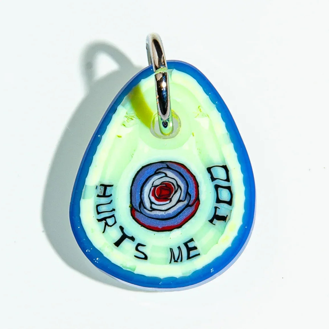 Colorful glass keychain pendant with blue border and 'HURTS ME TOO' text around a spiral design