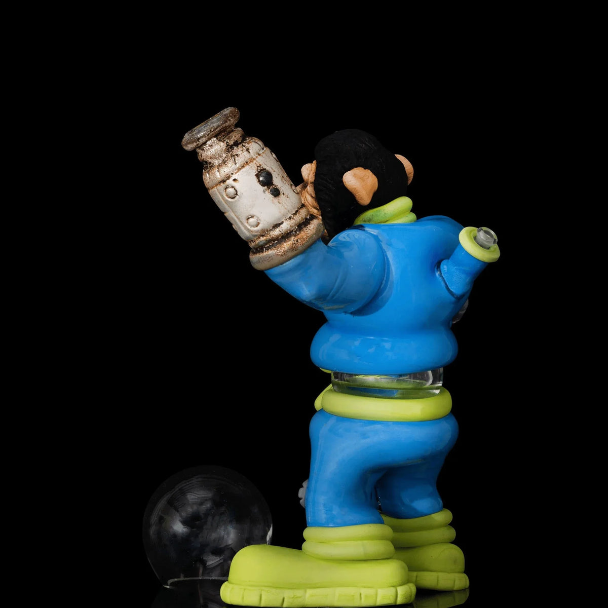 Colorful glass monkey-shaped water pipe with blue suit and green accents on black background