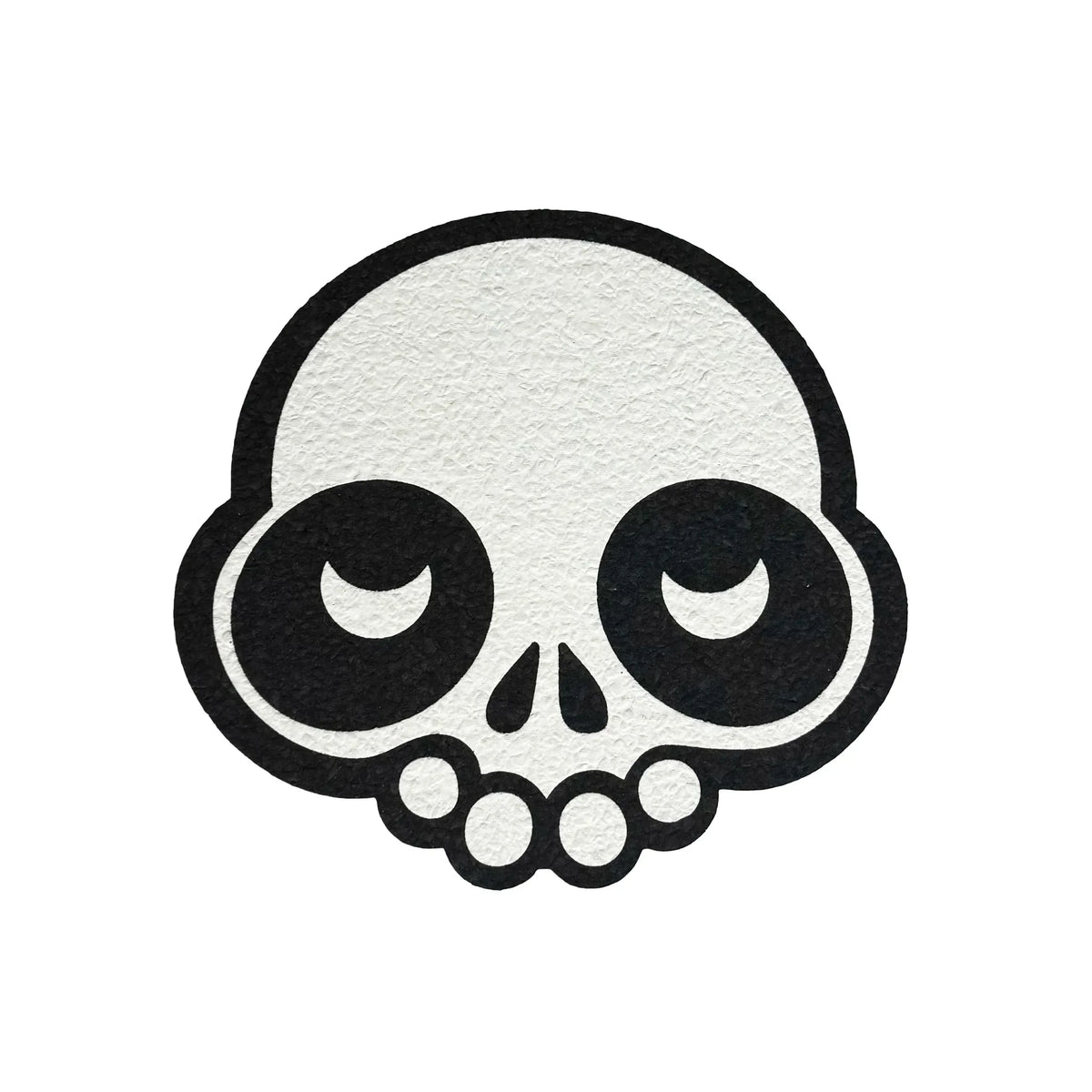 Black and white cartoon skull design on textured round mat, smoke shop accessory