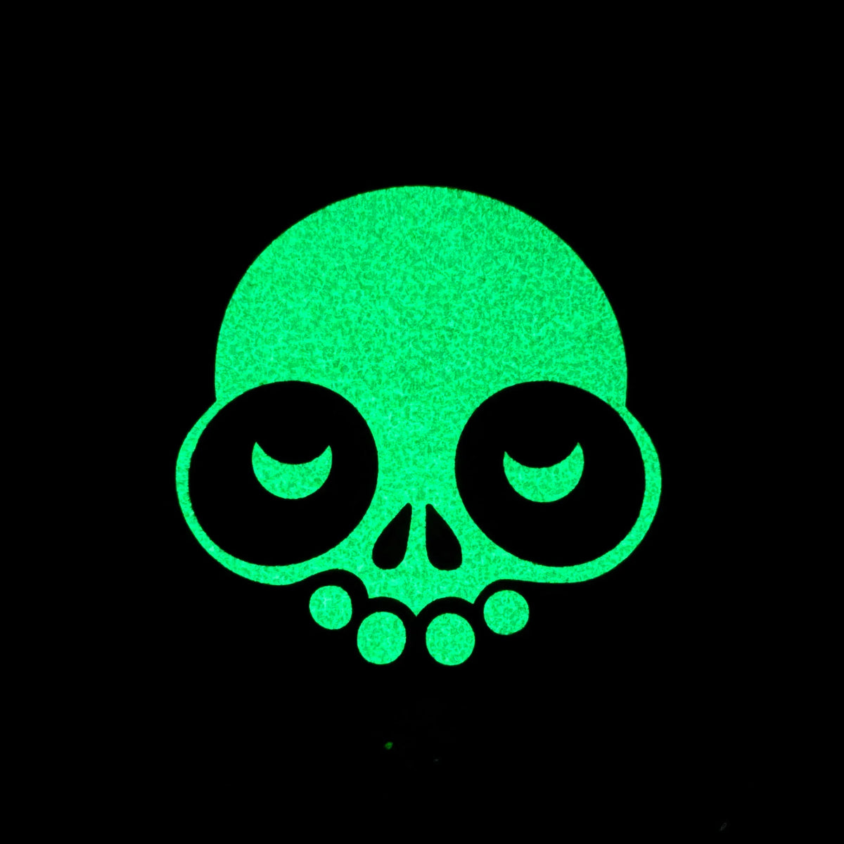 Glow in the dark skull design mat with large eyes on a black background