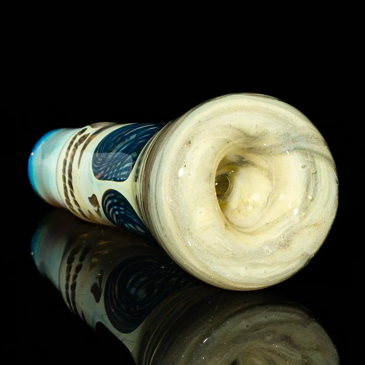 Close-up of artisan glass hand pipe with swirled colors and intricate design on black background