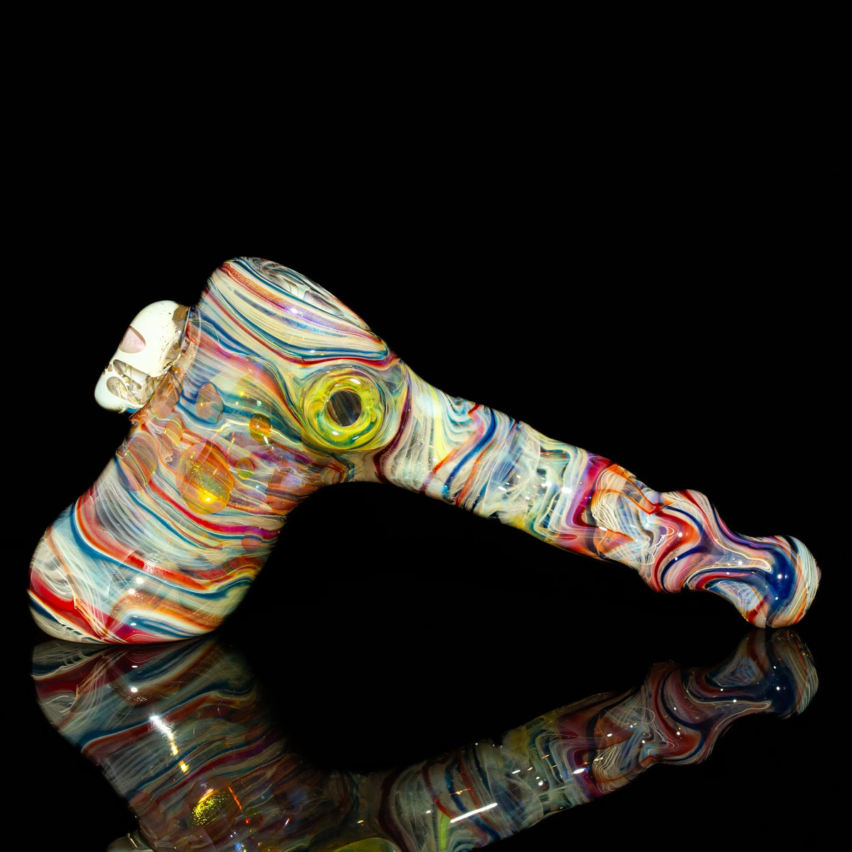 Colorful glass hammer pipe with swirled patterns and clear marble details on black background