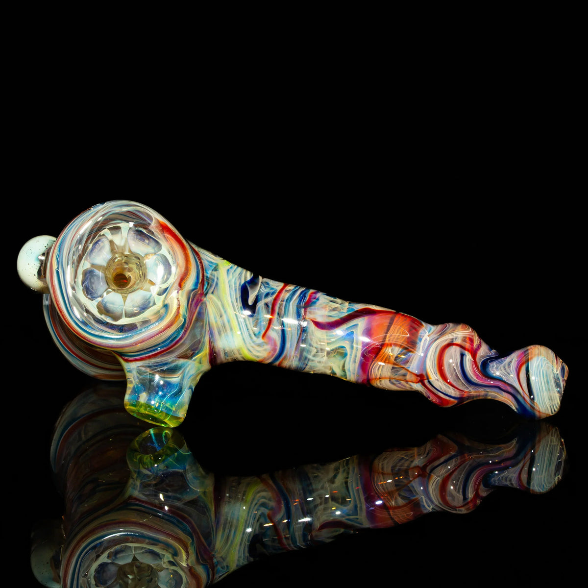 Colorful hand-blown glass pipe with vibrant swirls on black background