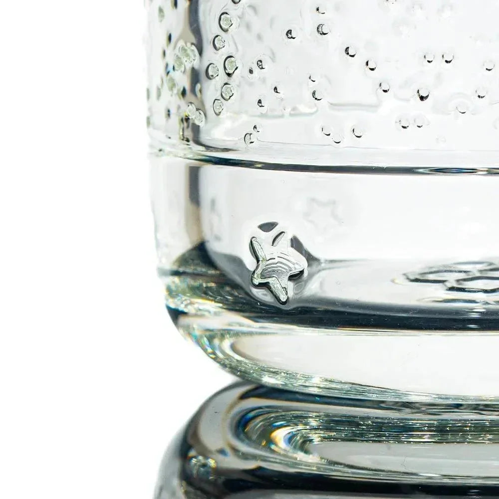 Close-up of clear heady glass pipe with unique star design and bubble accents