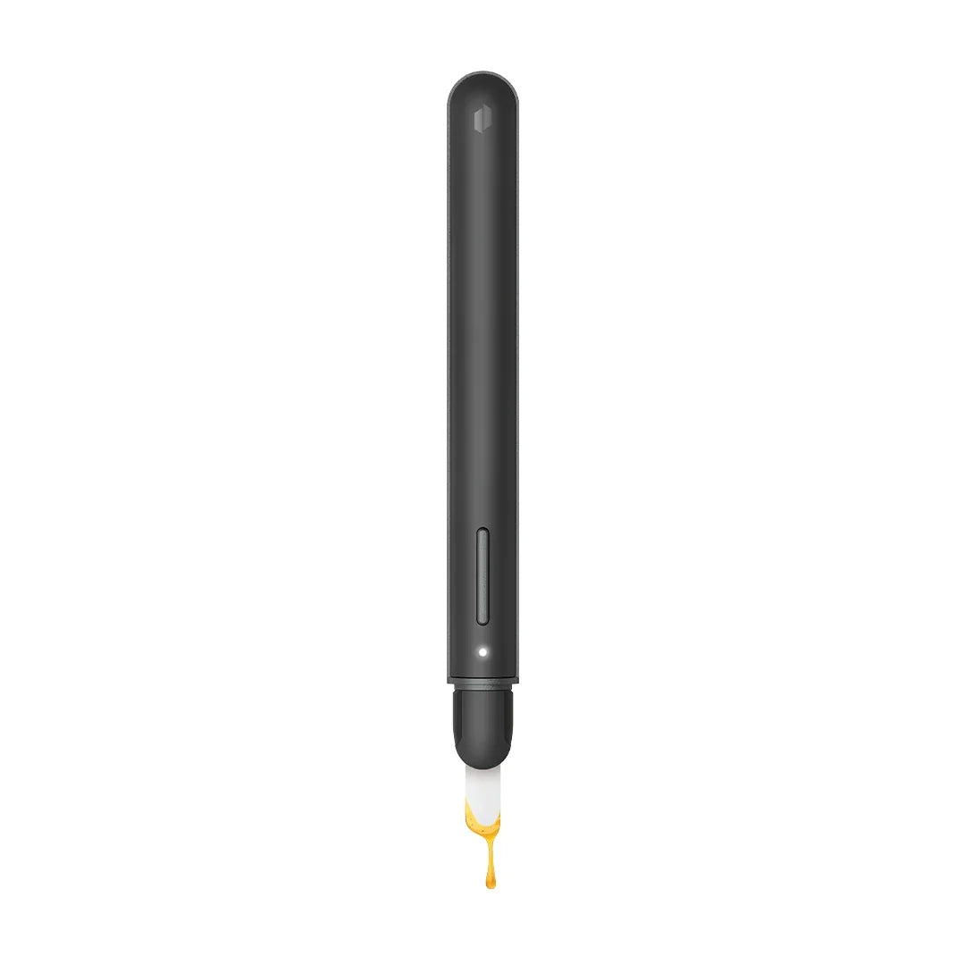 Black electronic hot knife with ceramic tip dispensing concentrate, isolated on white background.