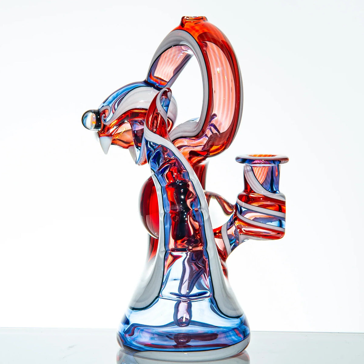 Colorful heady glass water pipe featuring a snake design with blue and red accents