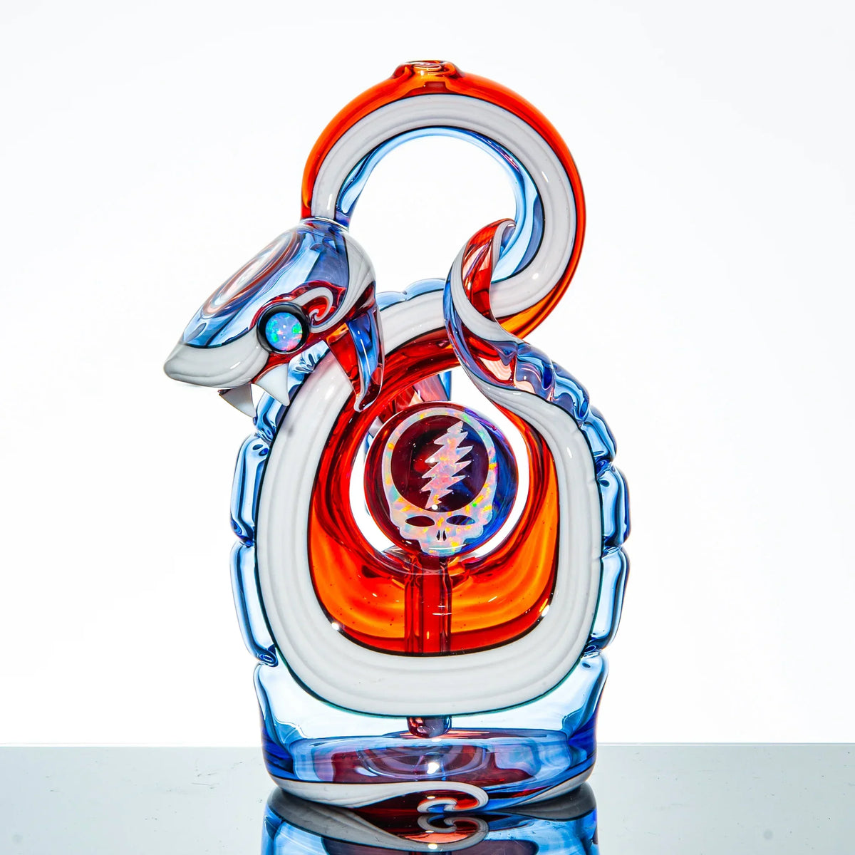 Colorful snake-shaped glass pipe with red, blue, and white accents and a skull design.