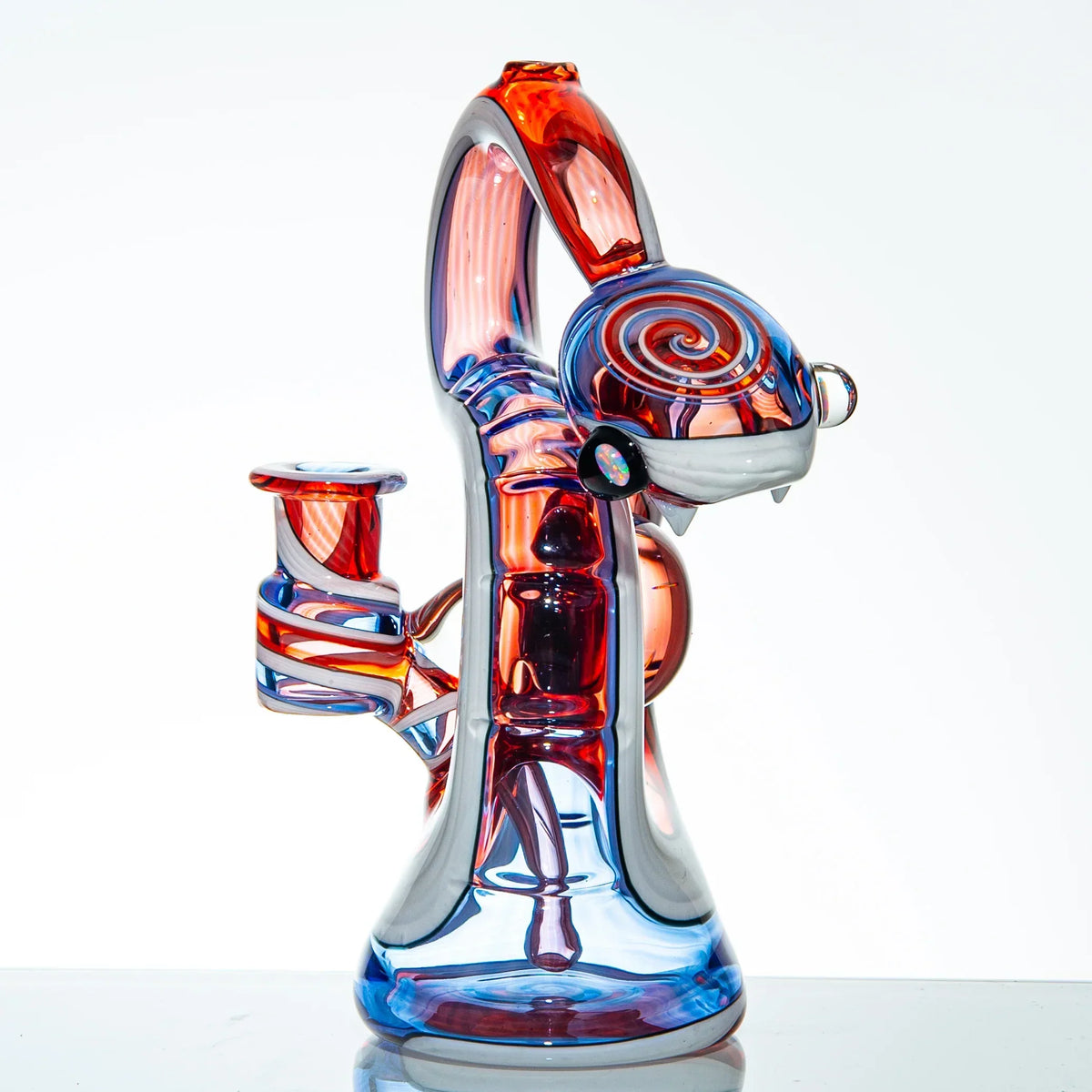 Heady glass water pipe with vibrant blue and red swirls, featuring a snake design