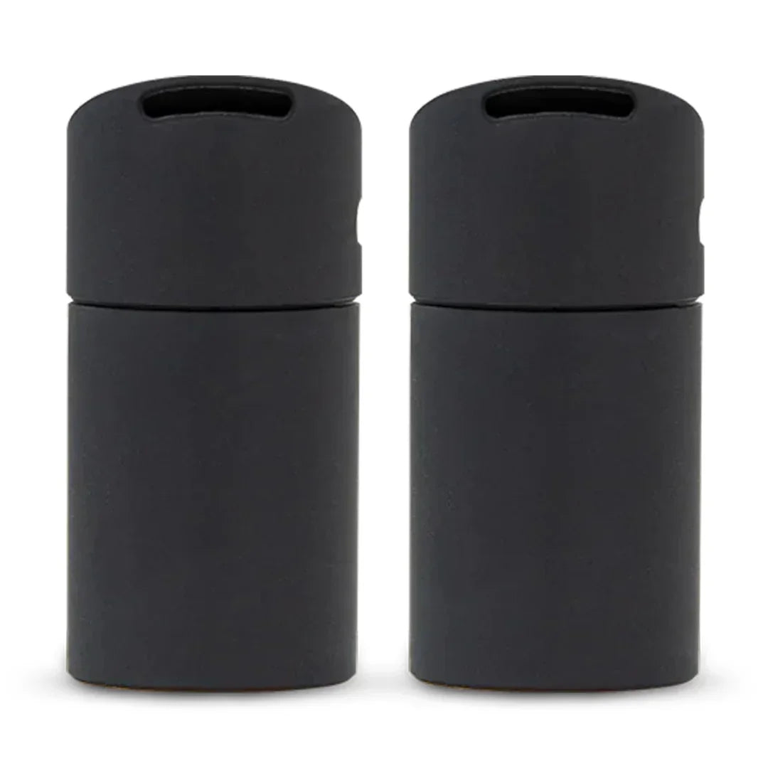 Pair of black airtight storage containers for herbs or concentrates on white background