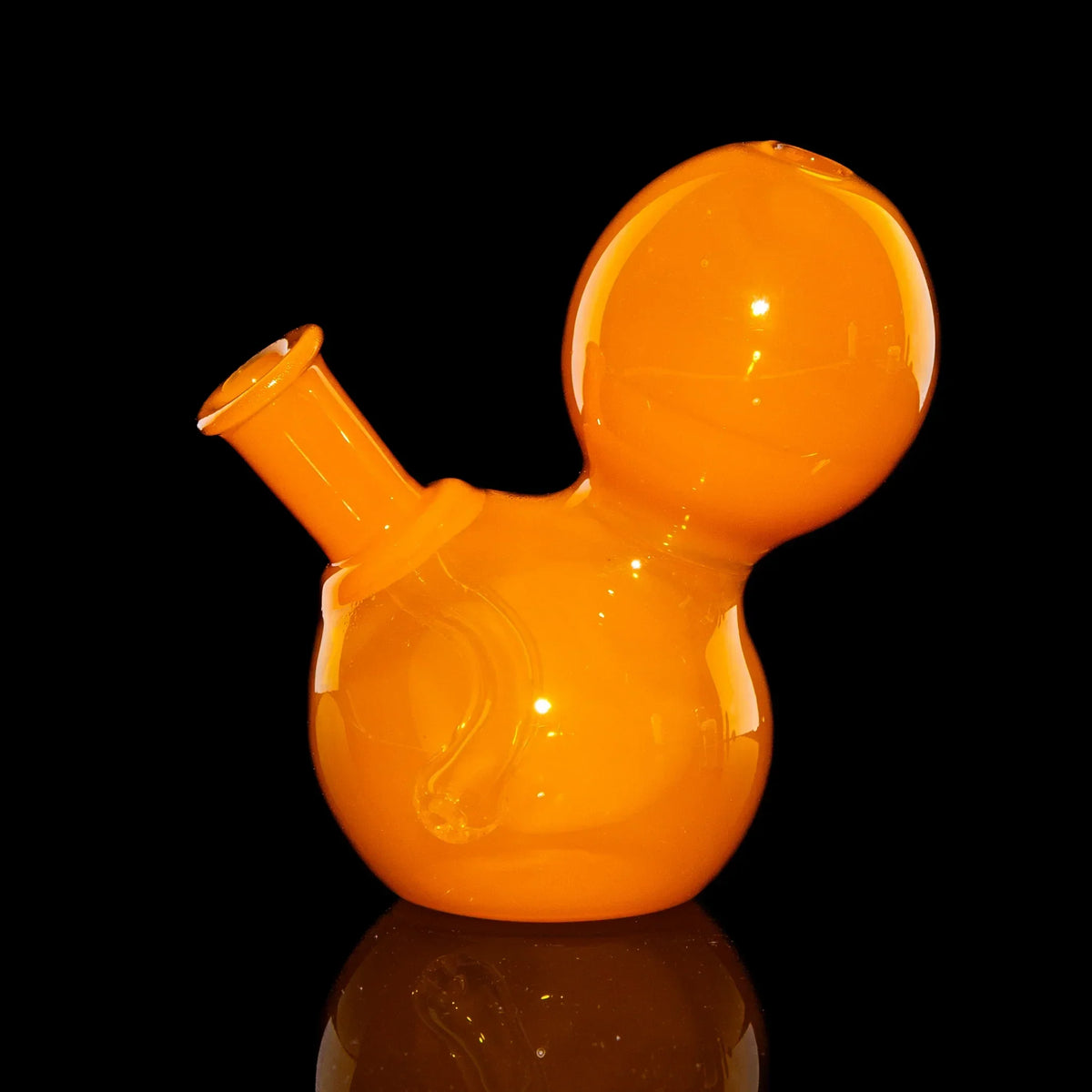 Bright orange glass water pipe with rounded design on black background