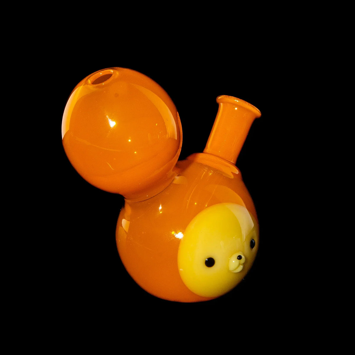 Orange glass rig with cute animal face design on black background, unique heady glass piece