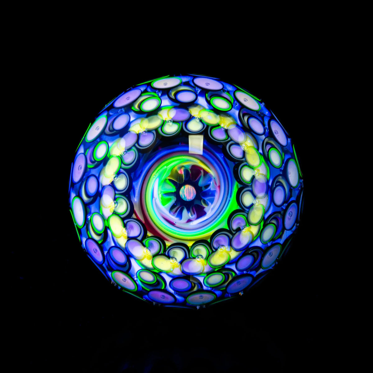 Colorful heady glass marble with intricate neon patterns and vortex design on black background
