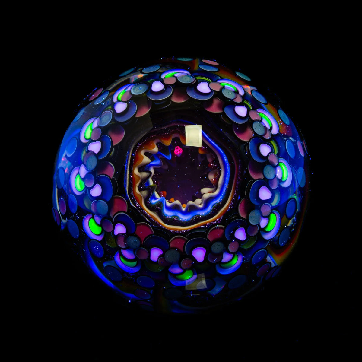 Colorful patterned heady glass marble with neon accents on black background