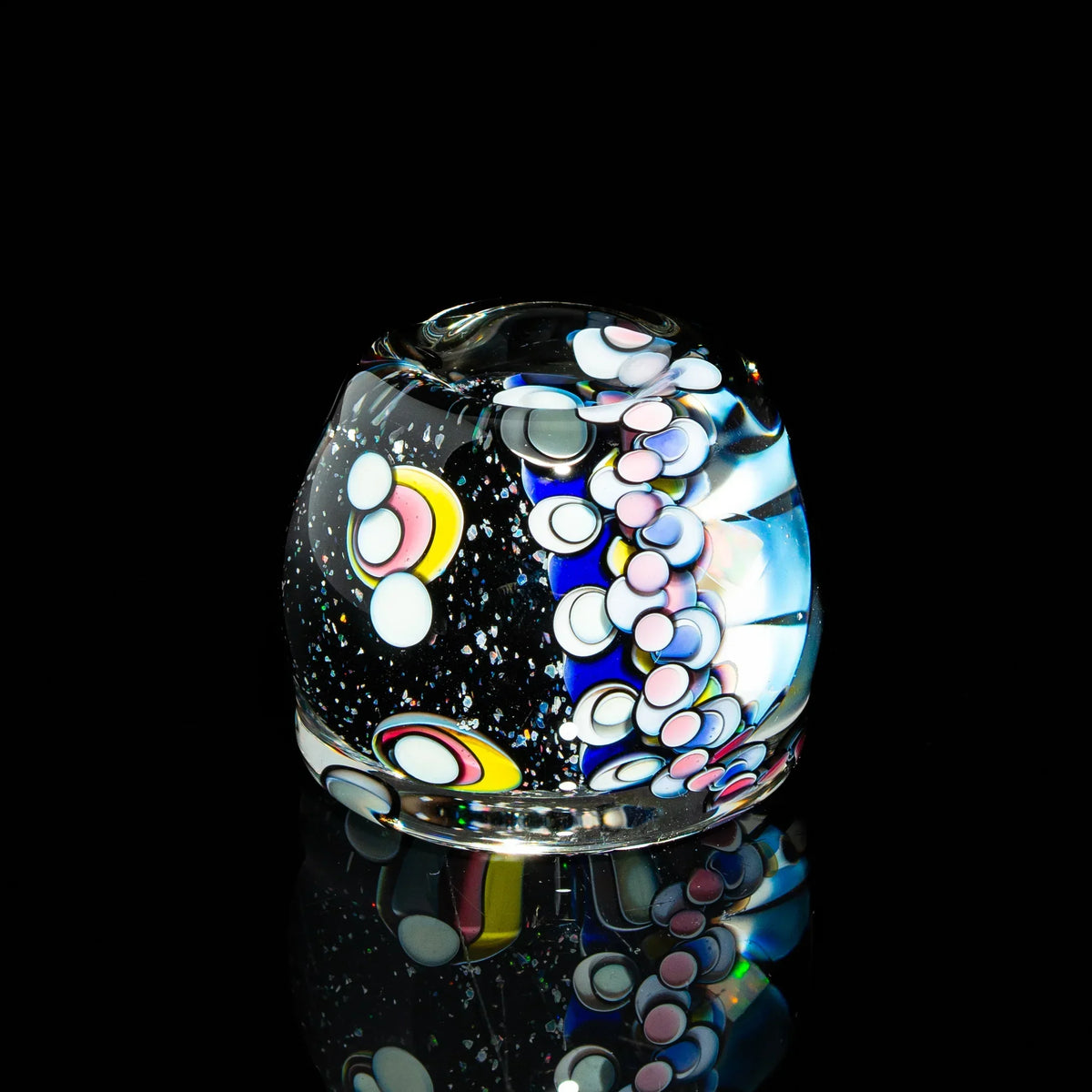 Colorful heady glass carb cap with abstract dotted design, displayed on a black background