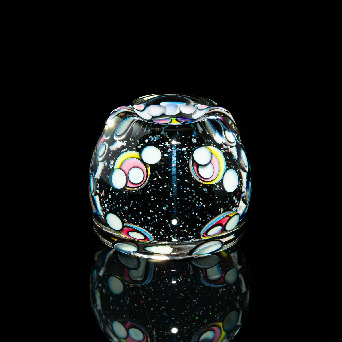 Colorful heady glass carb cap with cosmic dot pattern on black background