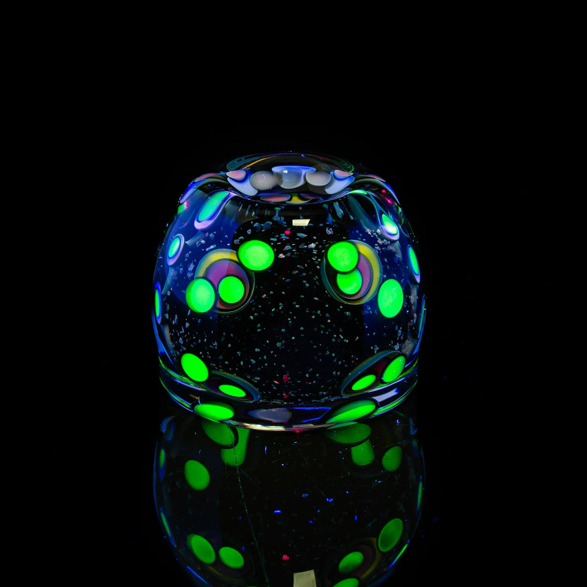 Heady glass art marble with glowing green polka dots on black background, reflective surface