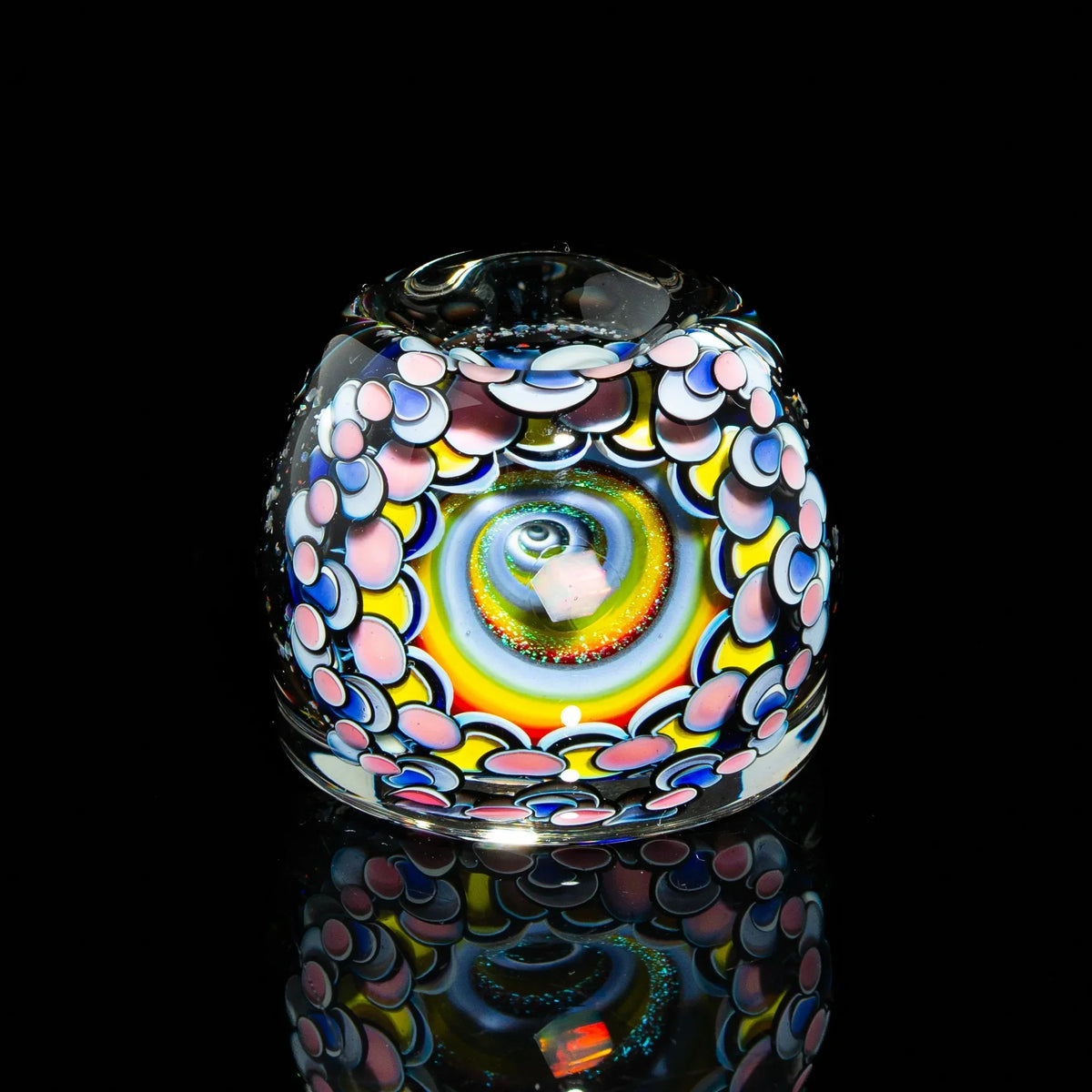 Heady glass carb cap with colorful spiral and intricate dot pattern on black background