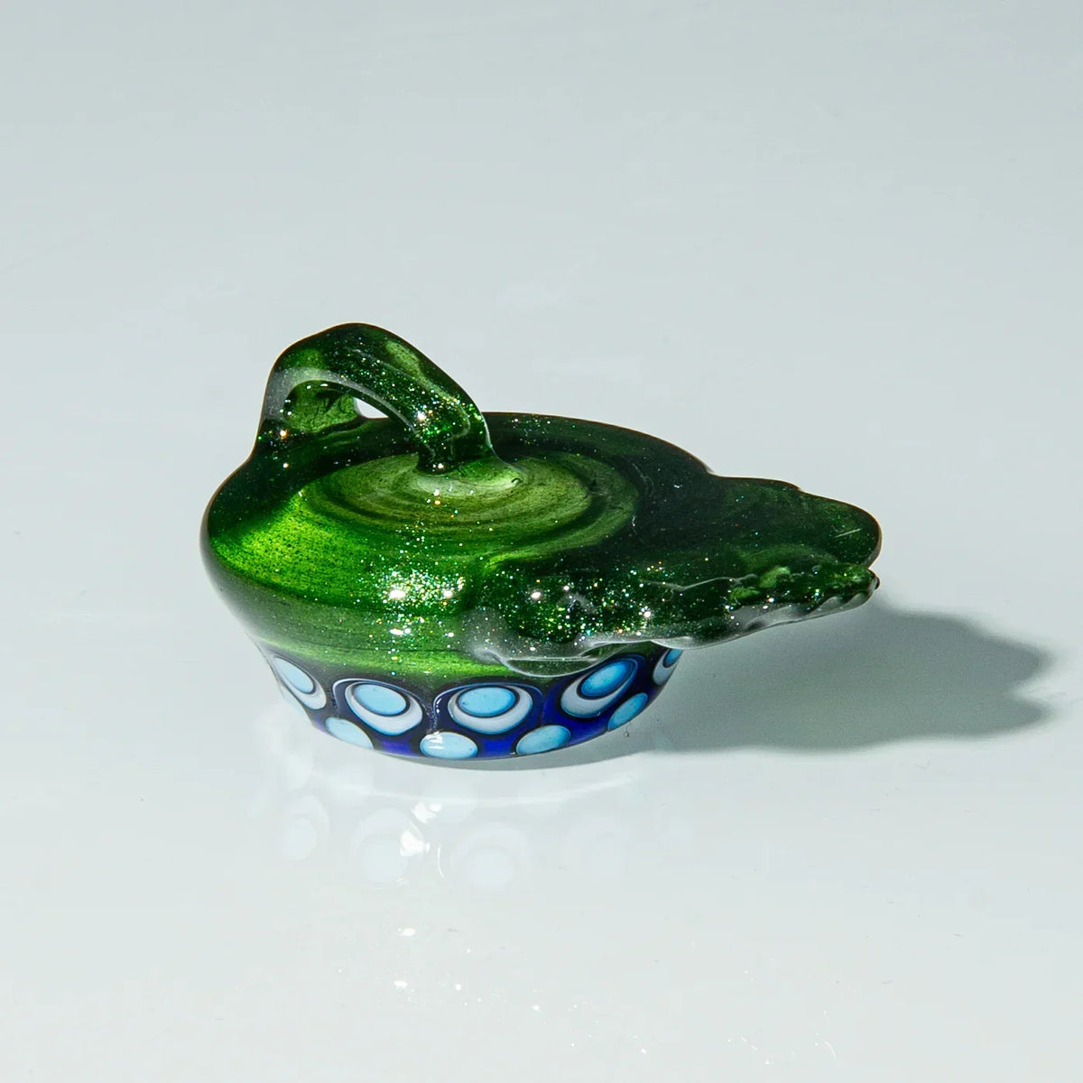 Green glass carb cap with handle and blue accent dots, displayed on white background.