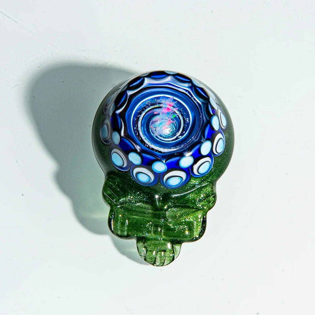 Green glass hand pipe with blue and white swirl pattern and intricate heady design