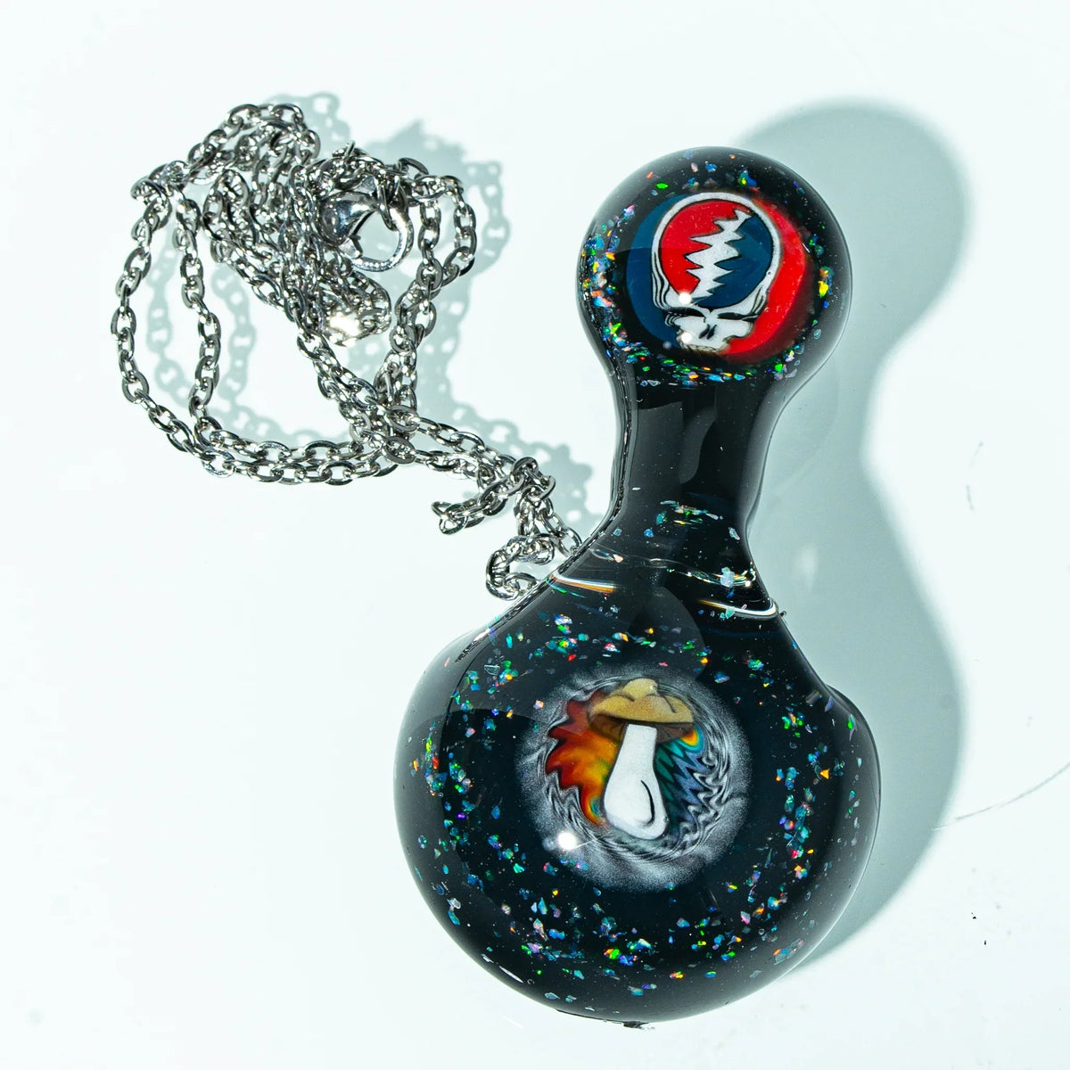Black glass pendant with colorful mushroom and lightning designs, silver chain included