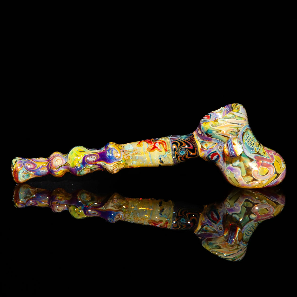 Colorful hand-blown glass pipe with intricate swirled patterns on a black background