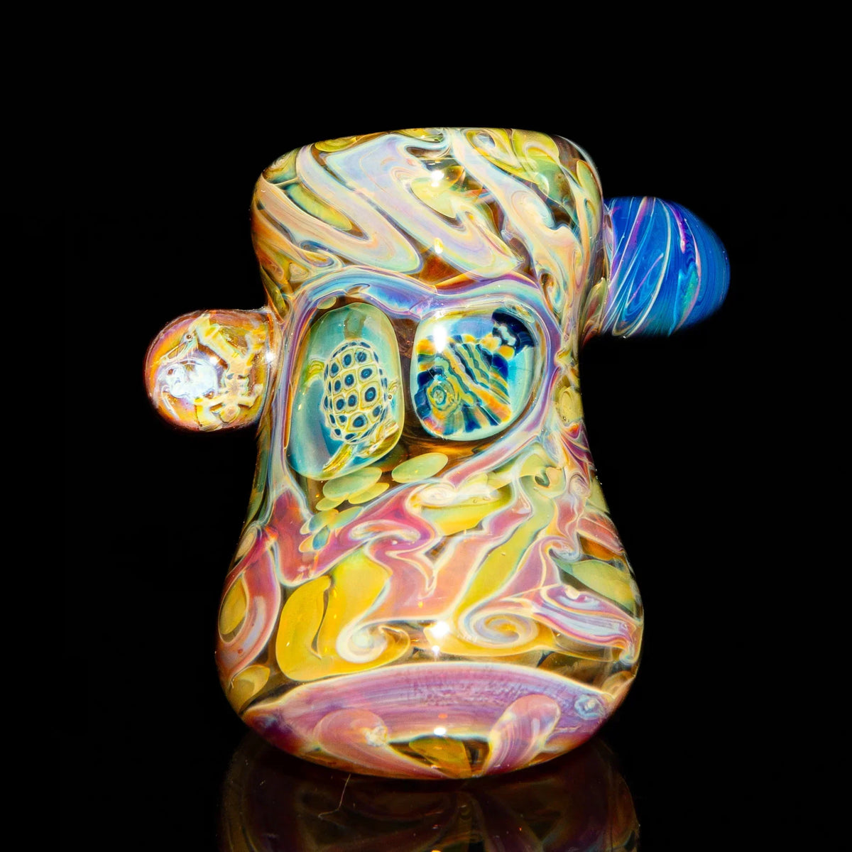 Colorful heady glass pipe with intricate patterns and marble accents on a black background