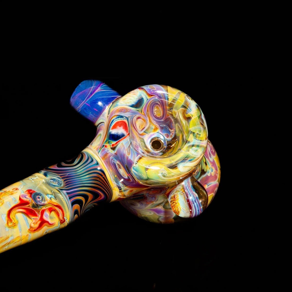 Handcrafted heady glass pipe with vibrant swirling colors on black background