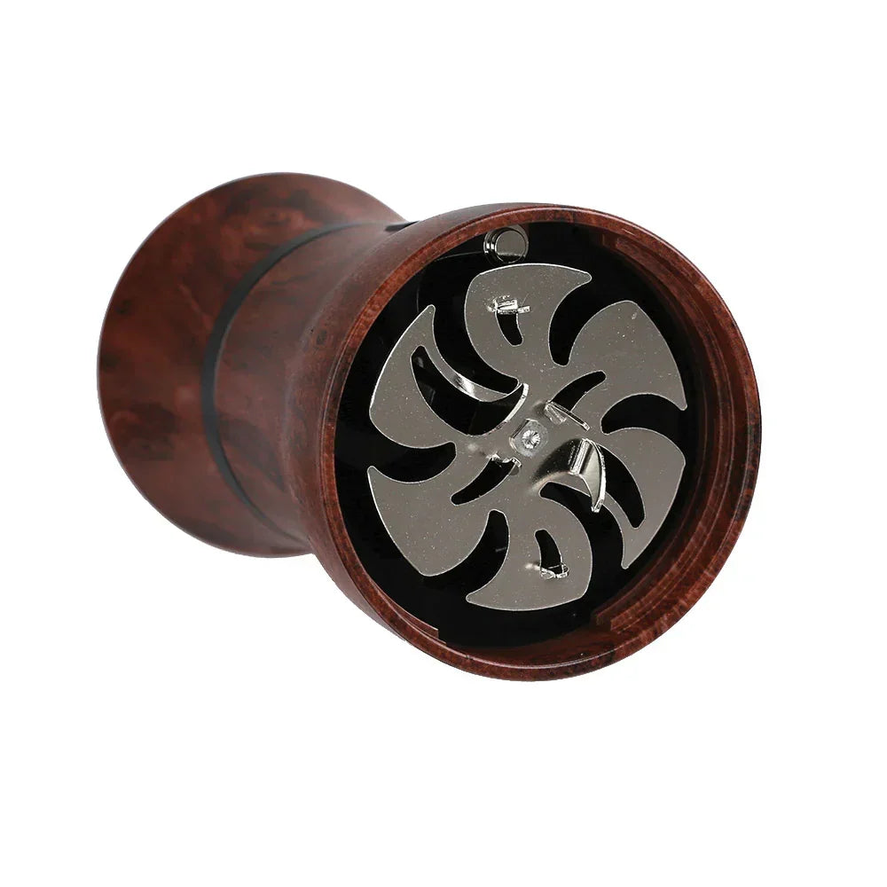 Electric herb grinder with wood finish and exposed metal blades, close-up view