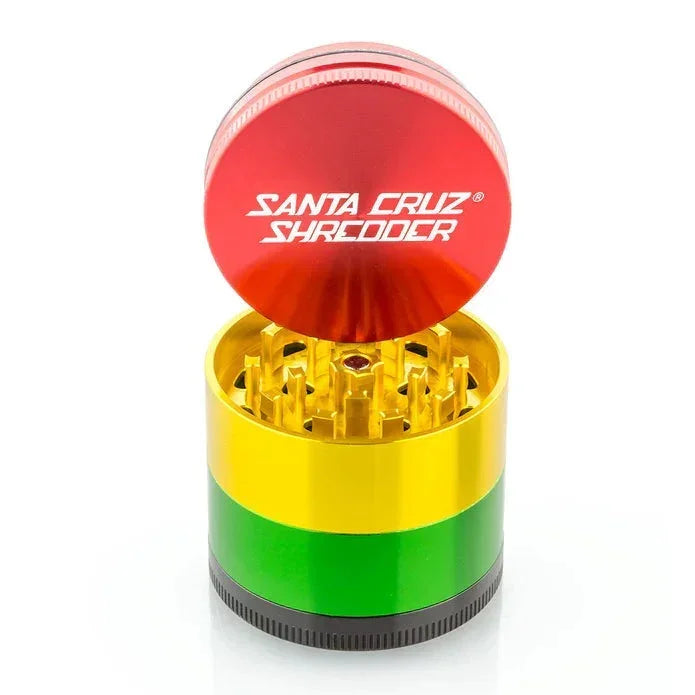 Santa Cruz Shredder rasta color metal herb grinder with red, yellow, green sections open to show teeth