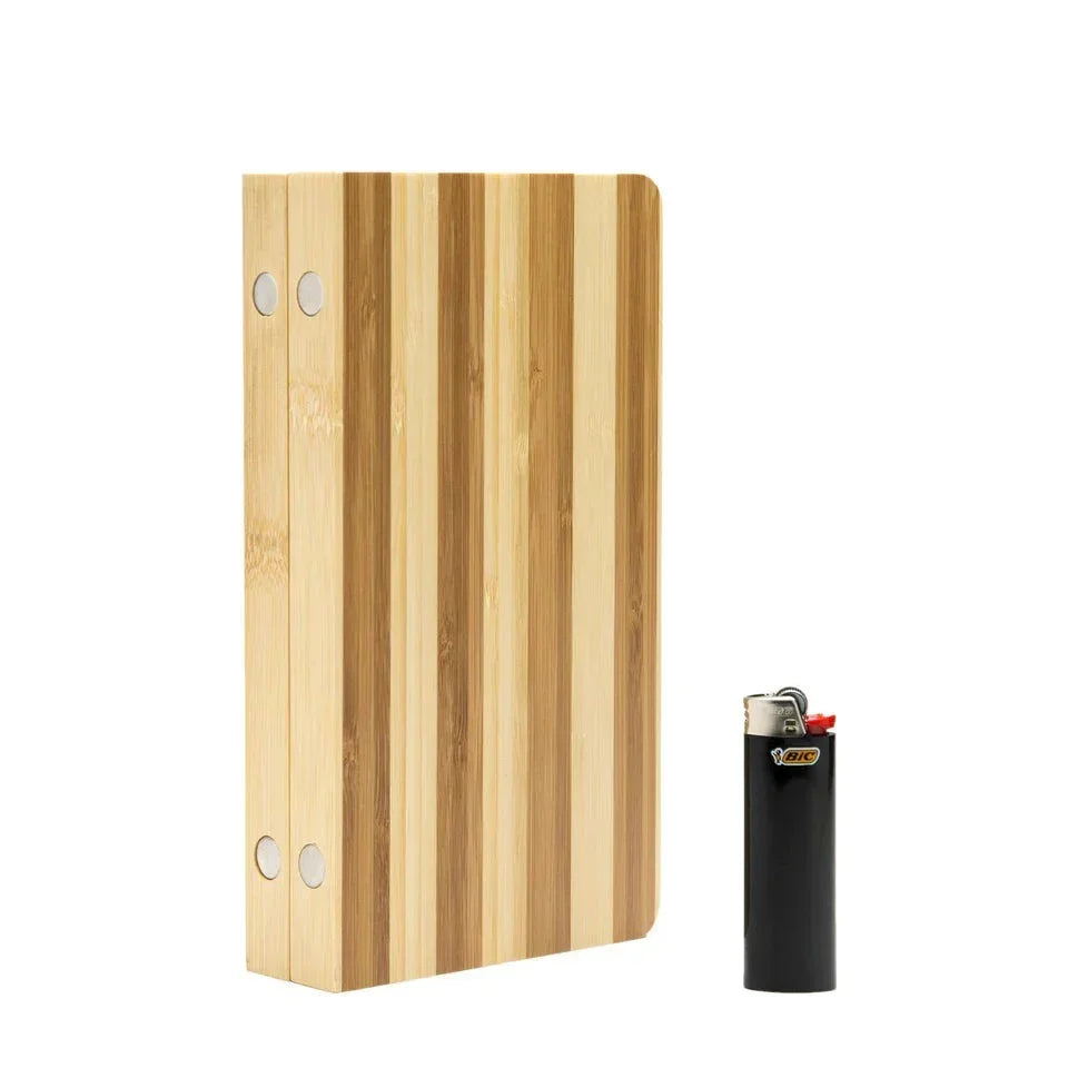Striped magnetic bamboo rolling tray standing upright beside a black lighter