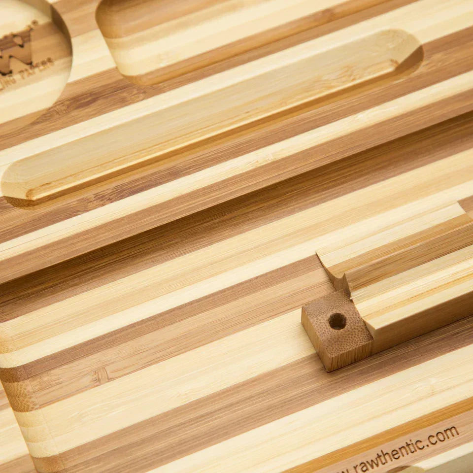 Striped magnetic bamboo rolling tray with carved compartments, close-up view