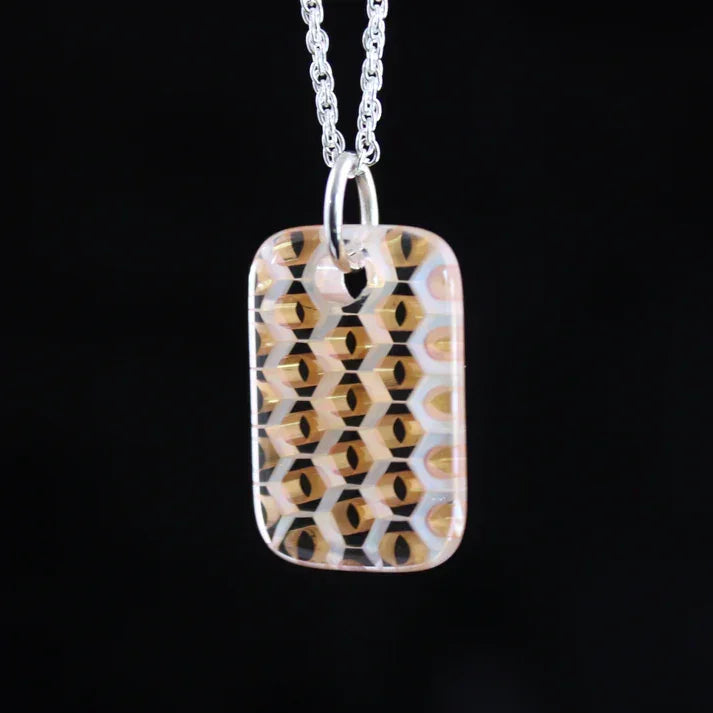 Geometric patterned glass pendant necklace with honeycomb design on a silver chain